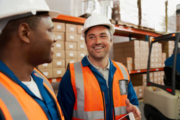 Close-up of happy multiracial employees in large warehouse