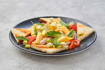 Pieces of toast, ham, boiled egg, cheddar and tomato