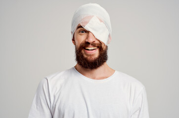 patient with a bandaged head and an eye blood isolated background