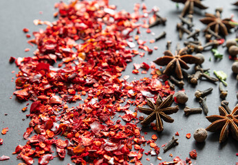Different aromatic spices on dark background, close-up