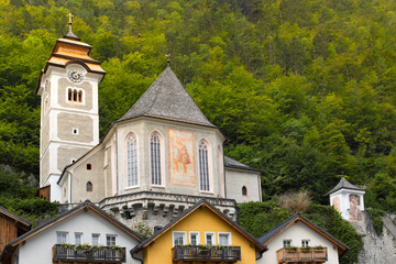 Fototapeta na wymiar Old church tower, roof of houses in the village of Hallstatt, Salzkammergut, Austria
