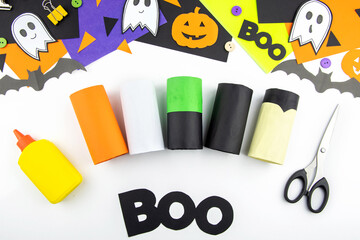 Craft with a child for Halloween from rolls of toilet paper and colored paper. Step-by-step instruction.