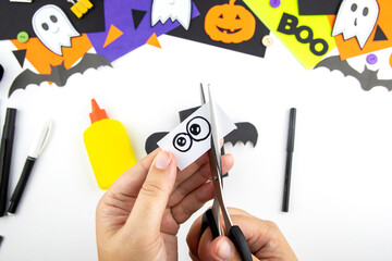 Craft with a child for Halloween from rolls of toilet paper and black paper bat. Step-by-step instruction. step 7.