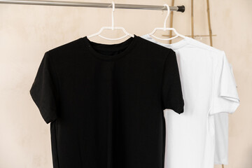 White and black T-shirts on hangers for design presentation