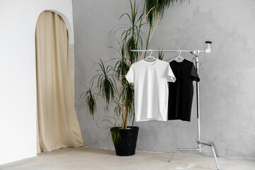White and black T-shirts on hangers for design presentation