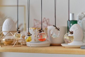 Fototapeta na wymiar wall shelf with interior details. in the foreground pendant with a colorful flower inside.