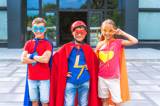 Group of young schooler wearing superhero costumes