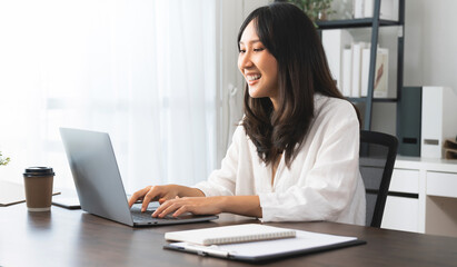 Young asian woman using Laptop with working creative at home office.