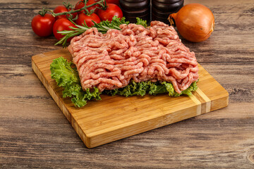 Raw pork minced meat over board