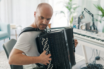 Professional musician playing the accordion - obrazy, fototapety, plakaty
