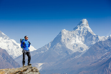 Hiker enjoying the view on the Everest trek in Himalayas, Ama Dablam mountain view, Nepal