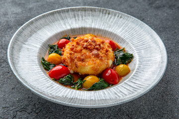 Chopped meat cutlet baked with cheese and grilled vegetables. Ready menu for the restaurant. Neutral gray blue textured background