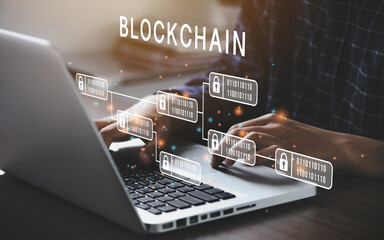 Businessman using a computer to Blockchain technology concept with a chain of encrypted blocks to...
