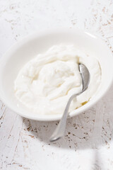 thick Greek yogurt in a bowl, vertical