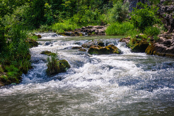 fast winding small mountain river flows among stones and gra © Coka