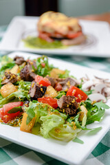 Salad with beef, tomatoes, fresh lettuce salad and arugula, raw mushrooms and great dressing from dijon mustard.