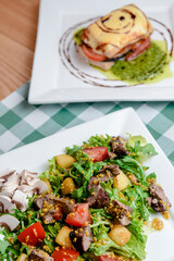 Salad with beef, tomatoes, fresh lettuce salad and arugula, raw mushrooms and great dressing from dijon mustard.