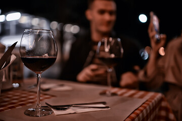 glasses of toast chin chin, hands with glasses of white wine in a street cafe