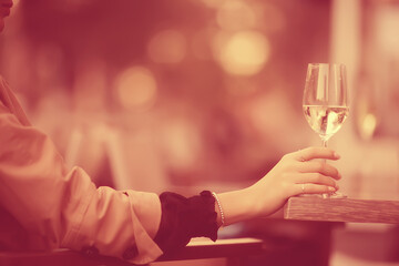 glasses of toast chin chin, hands with glasses of white wine in a street cafe