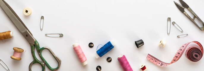 Flat lay composition with threads, scissors, buttons, needles, pins and other sewing accessories on...