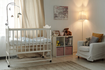 Interior of large cozy room of newborn baby with cradle, toys and furniture
