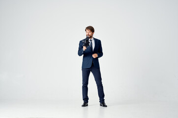 man in a suit holding an umbrella over his head protection from the rain elegant style studio