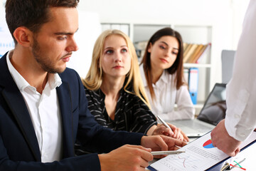 Group of people sit in office deliberate on problem