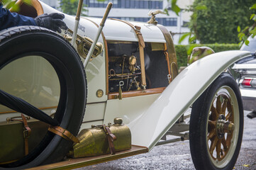 Close-up of elegant refined white gold antique retro sport renovated car 1914 on exhibition. Man...