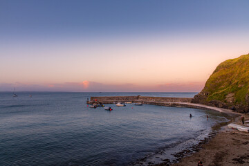 Looking out to sea at Gorran Haven, Cornwall, as the sun begins to set