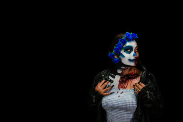 Halloween costume and makeup. Portrait of Calavera Catrina Zombie. Portrait of a woman with a painted face.