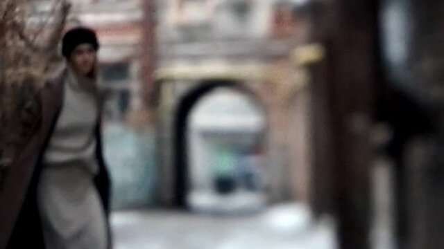 Real VHS video. 90s fashion. Retro trend. Hipster lifestyle. Young woman walking outdoors in autumn casual city street wear with damaged nostalgic glitch noise archive tape effect.