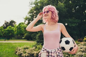 Portrait of attractive cheerful girl spending vacation free time holding ball touching specs on...
