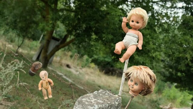 Scary dolls hanging on a barbed wire fence at the entrance to the ghost town of Pripyat. Chernobyl exclusion zone, Ukraine