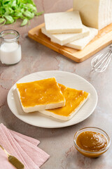 Sliced White Bread with kaya Jam. Coconut jam, also known as kaya jam, is a sweet spread made from a base of coconut milk, eggs and sugar.