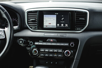Obraz na płótnie Canvas luxury car steering wheel and dashboard with display or monitor screen.