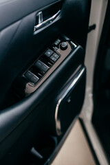 Obraz premium Car interior detail. Closeup of controls on the door