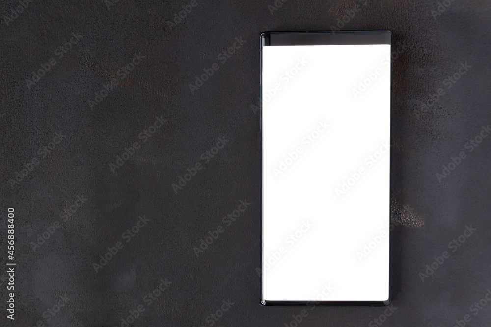 Poster mobile phone with blank screen mockup on black textured table background. mock-up for placing variou