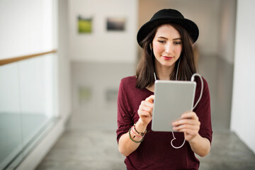 Woman listening to music from her tablet