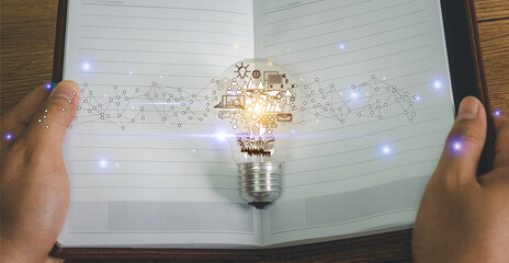 Hand businessman open notebook for New idea light bulb with business and finance icon. Creative ideas. Creativity innovation and solution concepts. Human Inspiration . New way solutions technology.