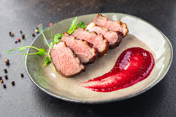 duck breast and garnish second course side dish fresh portion ready to eat meal snack on the table copy space food background rustic. top view keto or paleo diet