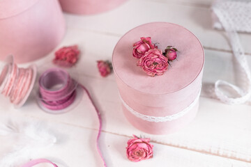 Beautiful pink round gift wrapping is decorated with narrowed roses. 