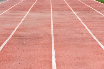 Fototapeta premium Red running tracks close-up at the stadium. Running love concept
