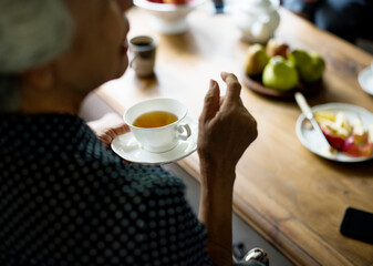 Fototapeta na wymiar Rear view of senior asian woman holding tea cup talking with friends
