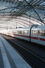A German intercity ICE train seen under an impressive station roof in Berlin