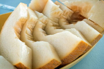 Plate with yummy melon slices on table close-up