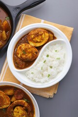 Indian non-vegetarian food  Homemade Egg Curry or Anda masala gravy, baida curry. Indian spicy food. Perfect Indian lunch. over moody background with copy space.