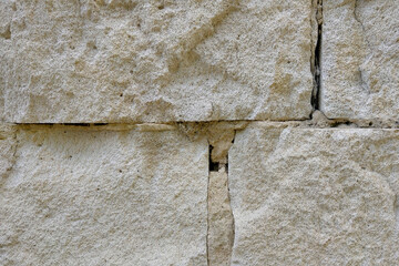 Close-up on the light brick wall of the building, background.