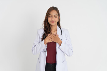 beautiful doctor in white uniform holding chest and eyes closed with patient expression