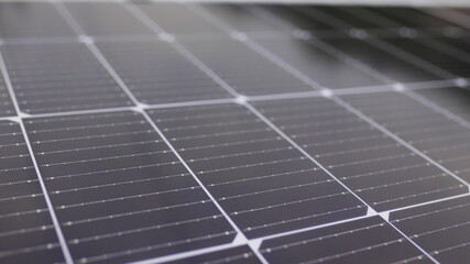 Photovoltaic solar panel extreme close up. Close-up of modern photovoltaic solar battery panels. Rows of sustainable energy solar panels installed on terrace. Solar panels on roof top. Panels at home.