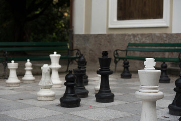 Empty park with big chess figures and empty benches on background, Tyrol, Innsbruck, Austria